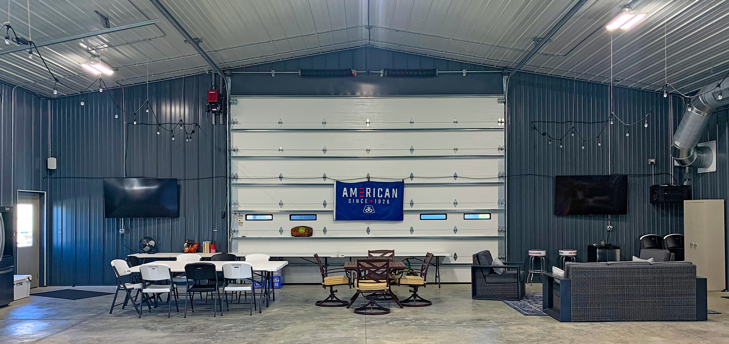 interior of a large suburban man cave with seating areas and big-screen TVs